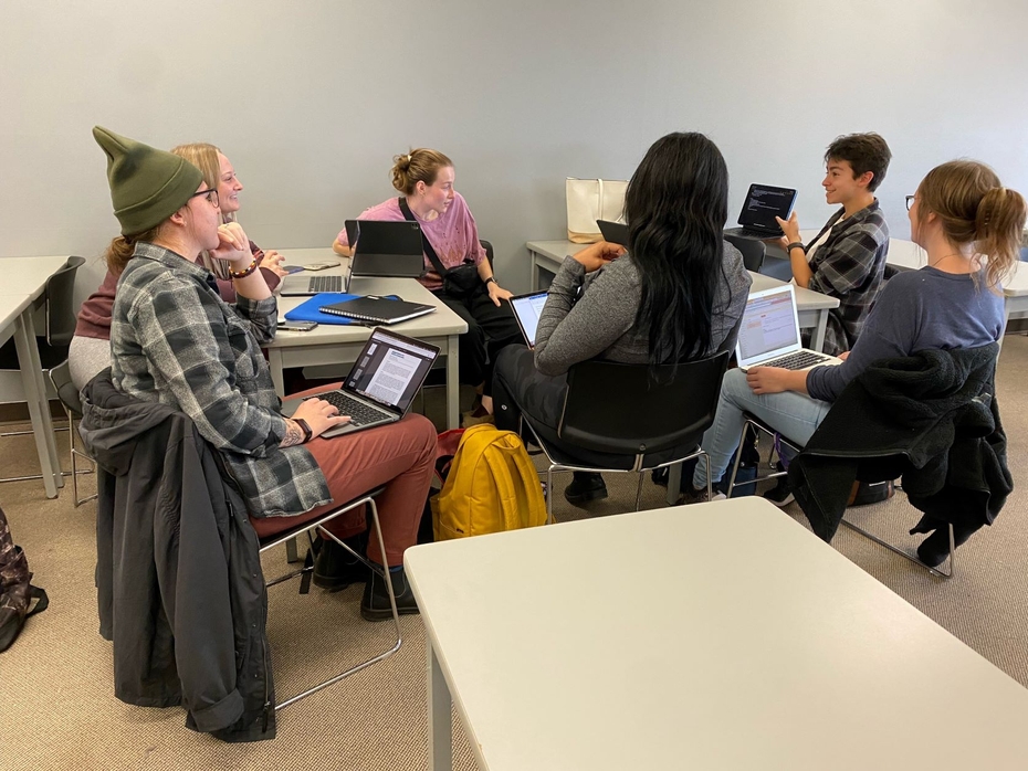 Police Foundations and BPSYC students sit among desks in a classroom at SLC with laptops open in front of them.